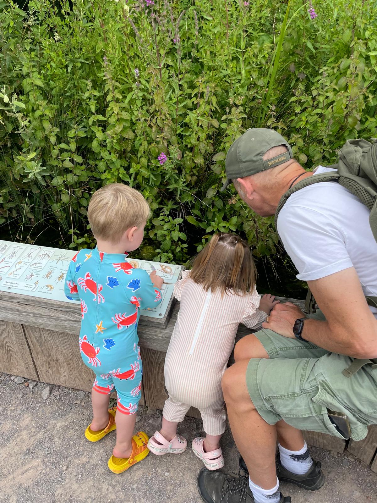 Ian exploring nature with his grandchildren
